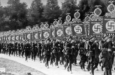 Nazi parade with swastika flags.